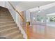 Spacious living room featuring a fireplace, large windows, and stairs to the second floor at 147 Calico Loop, Grantville, GA 30220