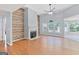 Spacious living room featuring hardwood floors, a fireplace, and large windows at 147 Calico Loop, Grantville, GA 30220