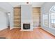 Bright living room featuring a fireplace, wood floors, and a neutral color palette at 147 Calico Loop, Grantville, GA 30220