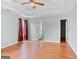 Light-filled main bedroom showcasing tray ceilings, neutral paint, and hardwood floors at 147 Calico Loop, Grantville, GA 30220
