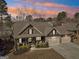 Aerial view of a beautiful home with a spacious three-car garage and cozy front porch at 266 Hanover Dr, Villa Rica, GA 30180