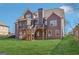 Exterior of home with a spacious backyard and wooden deck and stairs at 266 Hanover Dr, Villa Rica, GA 30180