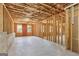 Unfinished basement with visible framework, insulation, and concrete flooring, offering potential for customization at 266 Hanover Dr, Villa Rica, GA 30180
