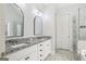 Double vanity bathroom with framed mirrors, white cabinets, and a tiled floor at 266 Hanover Dr, Villa Rica, GA 30180