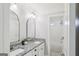 Bathroom with double sink vanity, granite countertops, white cabinets, and mirrors at 266 Hanover Dr, Villa Rica, GA 30180