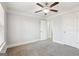 Bedroom with neutral carpet, ceiling fan, and multiple doorways at 266 Hanover Dr, Villa Rica, GA 30180
