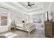 Spacious primary bedroom features a tray ceiling and large window letting in ample natural light at 266 Hanover Dr, Villa Rica, GA 30180