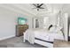 Bright primary bedroom showcases a tray ceiling and a flatscreen TV on a light-colored dresser at 266 Hanover Dr, Villa Rica, GA 30180