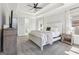 Inviting primary bedroom offers a tray ceiling with recessed lighting, a TV, and an ensuite bathroom at 266 Hanover Dr, Villa Rica, GA 30180