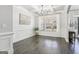 Bright dining room with wainscoting, hardwood floors, large window, and natural light at 266 Hanover Dr, Villa Rica, GA 30180