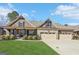 Charming home boasts a three-car garage, stone accents, manicured lawn, and inviting front porch at 266 Hanover Dr, Villa Rica, GA 30180