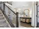 Elegant foyer with a staircase, hardwood floors, console table with decor, and a view of the entryway at 266 Hanover Dr, Villa Rica, GA 30180