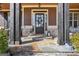Charming front porch with stone base, dark wood pillars, and stylish decor at 266 Hanover Dr, Villa Rica, GA 30180