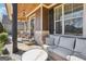 Cozy front porch featuring comfortable seating, stone accents, and a wood-paneled ceiling at 266 Hanover Dr, Villa Rica, GA 30180
