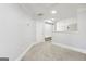 Hallway with neutral carpet and white trim. Door leading to additional rooms at 266 Hanover Dr, Villa Rica, GA 30180