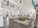 Open-concept living room with hardwood floors, stone fireplace, soaring ceilings, and a cozy sectional sofa at 266 Hanover Dr, Villa Rica, GA 30180