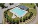 Aerial view of a community pool with surrounding trees, lounge chairs, and a nearby parking area at 266 Hanover Dr, Villa Rica, GA 30180