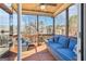 Inviting screened porch with comfortable seating, ceiling fan, and a peaceful outdoor view at 266 Hanover Dr, Villa Rica, GA 30180