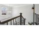 Staircase with wrought iron railings, large window, and contemporary light fixture at 266 Hanover Dr, Villa Rica, GA 30180