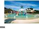Community waterpark featuring a splash pad, water slide, and bucket drop under a bright, cloud-filled blue sky at 266 Hanover Dr, Villa Rica, GA 30180