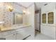 Vintage bathroom featuring wallpaper, marble countertops, a large mirror, and vanity with ample storage at 955 Landmark Dr, Sandy Springs, GA 30342