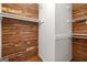 Custom closet featuring custom wood paneling, white shelving, and wood floors at 955 Landmark Dr, Sandy Springs, GA 30342