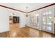 Open dining room featuring hardwood floors, a modern chandelier, and natural light from a large window at 955 Landmark Dr, Sandy Springs, GA 30342