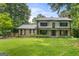 Charming two-story home featuring black accents, a brick facade, and a well-manicured lawn at 955 Landmark Dr, Sandy Springs, GA 30342