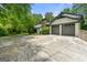 Attached two-car garage with a brick facade and a concrete driveway at 955 Landmark Dr, Sandy Springs, GA 30342