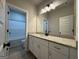 Bathroom features a white vanity with granite countertop and a view of the tub at 3019 Beverly Ct, Mcdonough, GA 30252