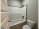 Bathroom features a white tub with gray accent tile and black hardware at 3019 Beverly Ct, Mcdonough, GA 30252