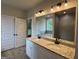 Bathroom features dual vanity with granite countertop and large mirror at 3019 Beverly Ct, Mcdonough, GA 30252