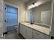 Bathroom features a white vanity with granite countertop and a view of the tub at 3019 Beverly Ct, Mcdonough, GA 30252