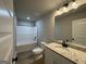 Bathroom features a white vanity with granite countertop and a view of the tub and toilet at 3019 Beverly Ct, Mcdonough, GA 30252