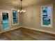 Dining room with modern chandelier and natural light, offers a view to the backyard at 3019 Beverly Ct, Mcdonough, GA 30252