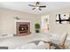 A cozy living room features a brick fireplace and comfortable seating arrangement at 332 Judy Dr, Mcdonough, GA 30253