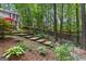 Backyard featuring a multi-level deck, stone pathways, and lush greenery, perfect for outdoor enjoyment at 103 Everhill, Peachtree City, GA 30269