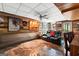Finished basement with wood paneling, a ceiling fan, and a leather reclining sofa at 103 Everhill, Peachtree City, GA 30269