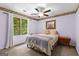 Bedroom with a floral wallpaper border, fan, window, and neutral carpet at 103 Everhill, Peachtree City, GA 30269