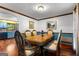 Formal dining room boasts a vintage-style table, ornate chairs, beautiful wood floors, and soft natural lighting at 103 Everhill, Peachtree City, GA 30269