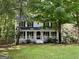Charming two-story home with inviting front porch and lush landscaping for a warm and welcoming curb appeal at 103 Everhill, Peachtree City, GA 30269