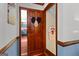 Hallway with a wood door and view into a blue themed kitchen at 103 Everhill, Peachtree City, GA 30269