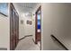 Upstairs hallway with carpet, wood trim, and a view to the tiled bathroom at 103 Everhill, Peachtree City, GA 30269