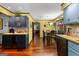 The cozy kitchen features updated tile backsplash, wood countertops, and light blue cabinets at 103 Everhill, Peachtree City, GA 30269