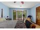 Large bedroom features a bay window with window seat, ceiling fan, and an armchair at 103 Everhill, Peachtree City, GA 30269