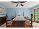 Spacious bedroom is painted a serene blue and features a ceiling fan and large windows at 103 Everhill, Peachtree City, GA 30269