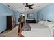 Bedroom with blue walls, soft carpet, wooden dressers, and doorway access to the ensuite bath at 103 Everhill, Peachtree City, GA 30269