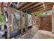 An outdoor shower area features corrugated metal walls and a stone pathway, offering a rustic feel at 103 Everhill, Peachtree City, GA 30269