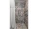 Custom tiled shower with a built-in shower niche and multiple shower heads at 103 Everhill, Peachtree City, GA 30269