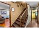 Carpeted staircase leads to upper level; hallway shows wood floors and neutral paint at 103 Everhill, Peachtree City, GA 30269